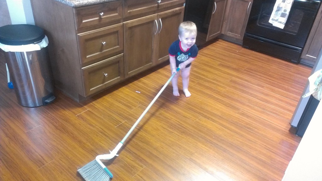 Josh, about 18 months old, "helping" with sweeping the kitchen