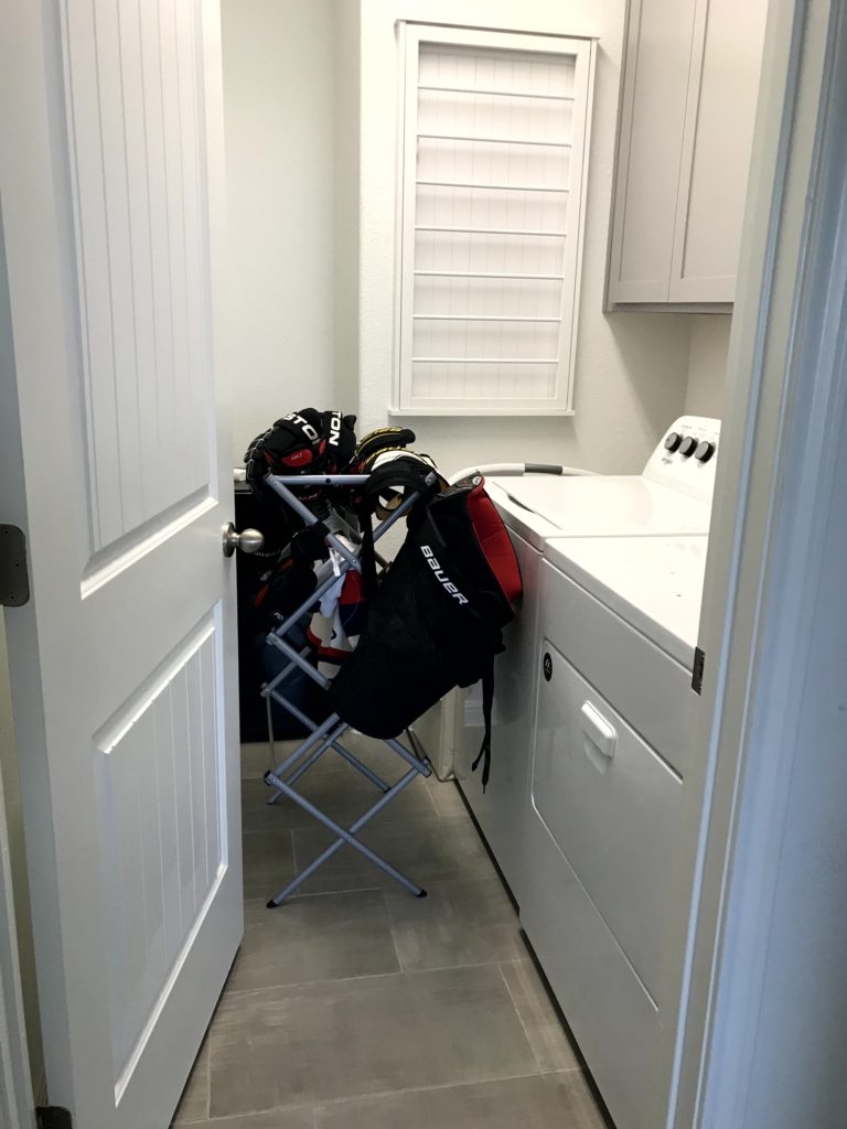Collapsible Drying Rack in Small Laundry Room Showing Need for Wall-Mounted Drying Rack